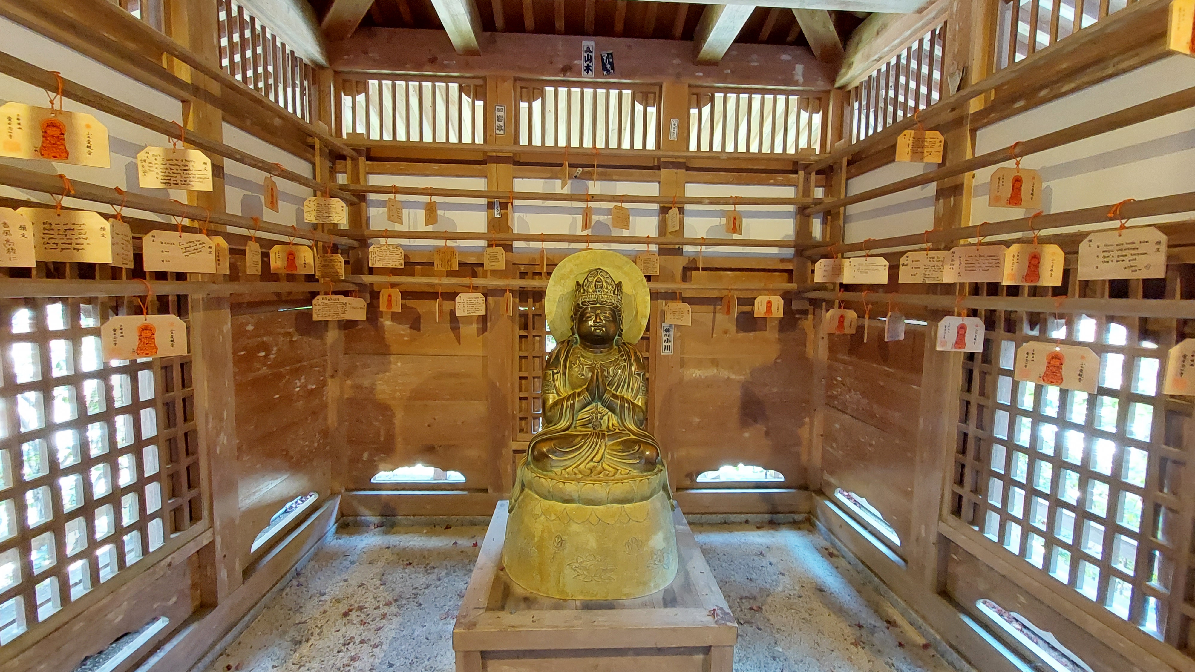 AWO journalist and writer, Ameena Navab, stands amidst the rakan statues of Otagi Nenbutsuji, the most unique temple 
in Kyoto, to photograph them Photo Credit: AWO staff