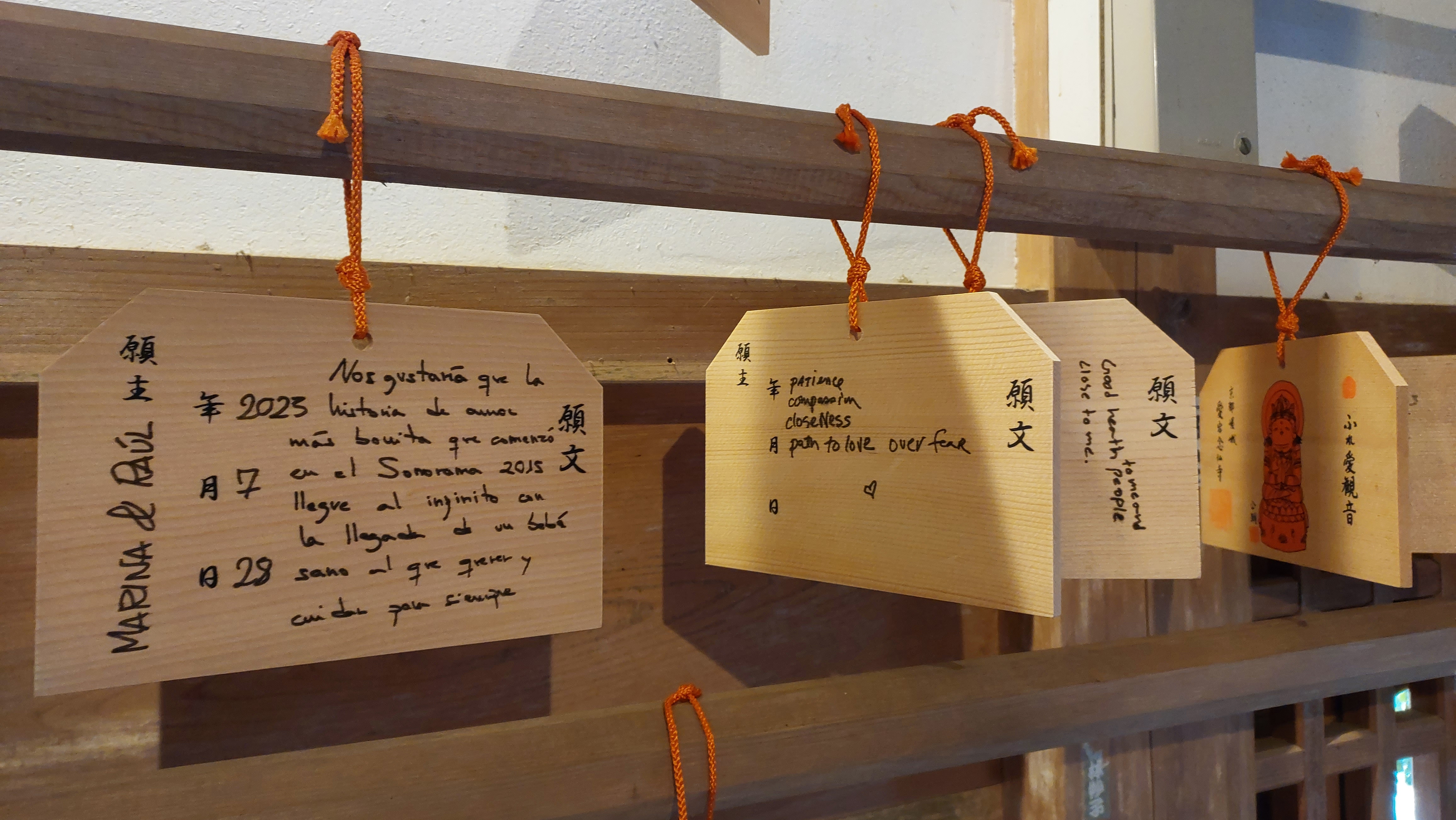 Visitors write their wishes on wooden papers and hang them in the Fureai Kannon shrine at Otagi Nenbutsuji in hopes for them to come true Photo Credit: AWO staff
