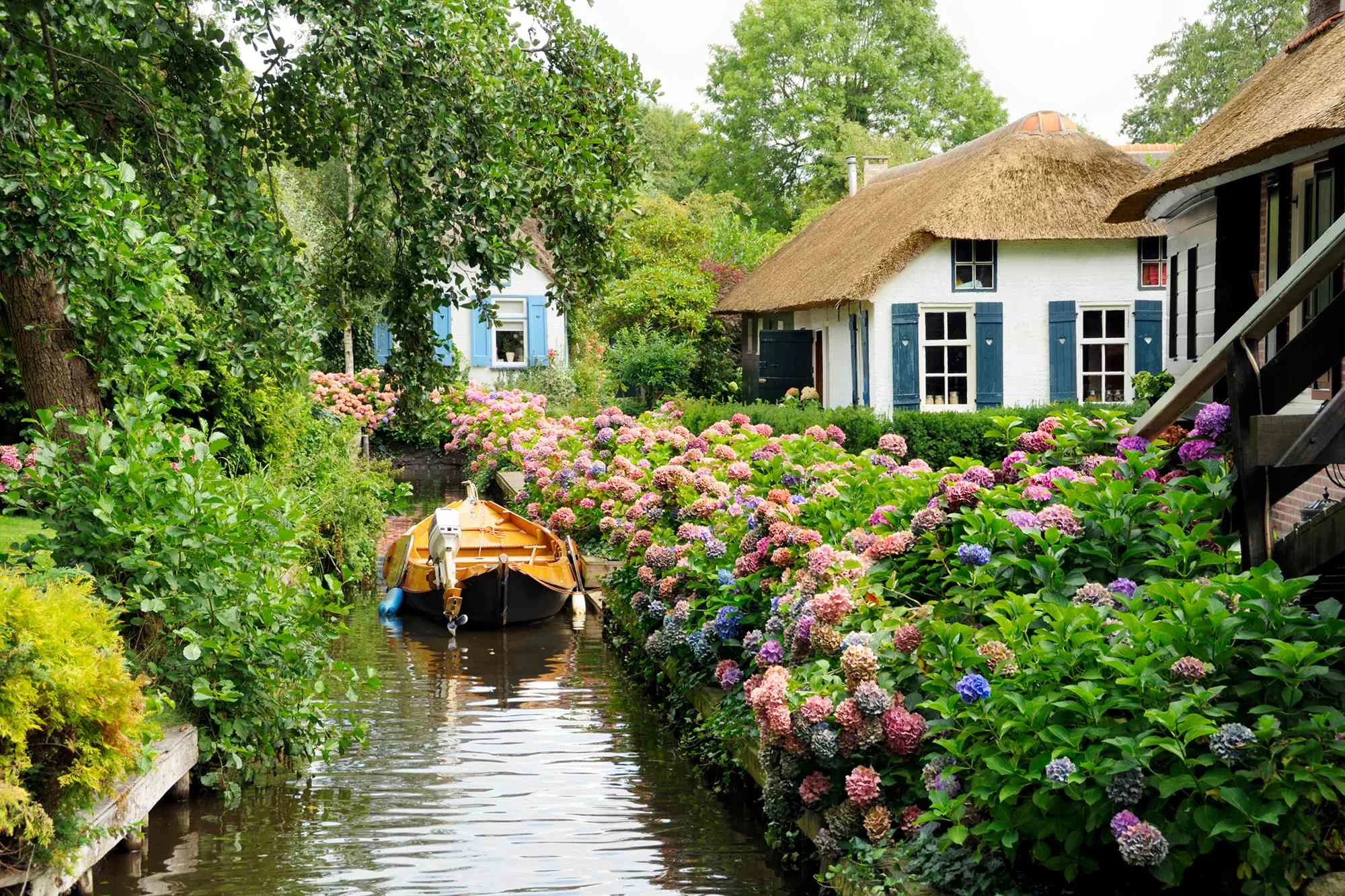 A boat paddles through Giethoorn, one of the beautiful canals in Netherland